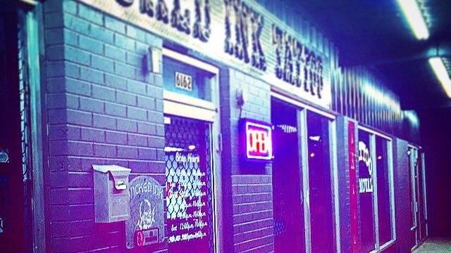 Wicked Ink Tattoo storefront on Clinton Highway at night
